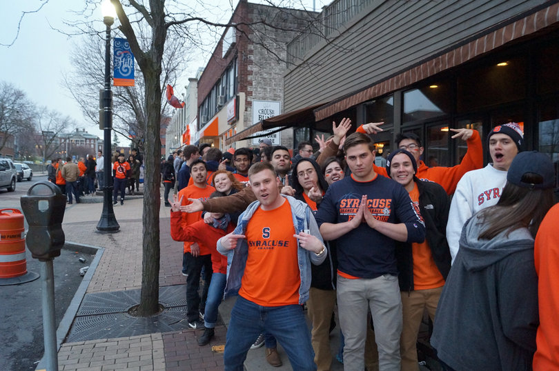 Fans wait in a line on Marshall Street on Saturday. 