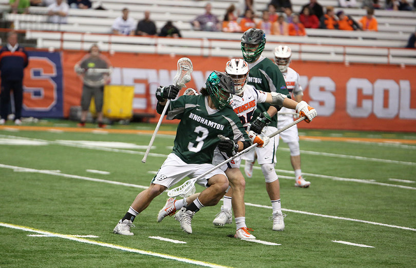 Syracuse's Scott Firman defends a Binghamton player driving toward the net. He is the Orange's top long-stick midfielder.