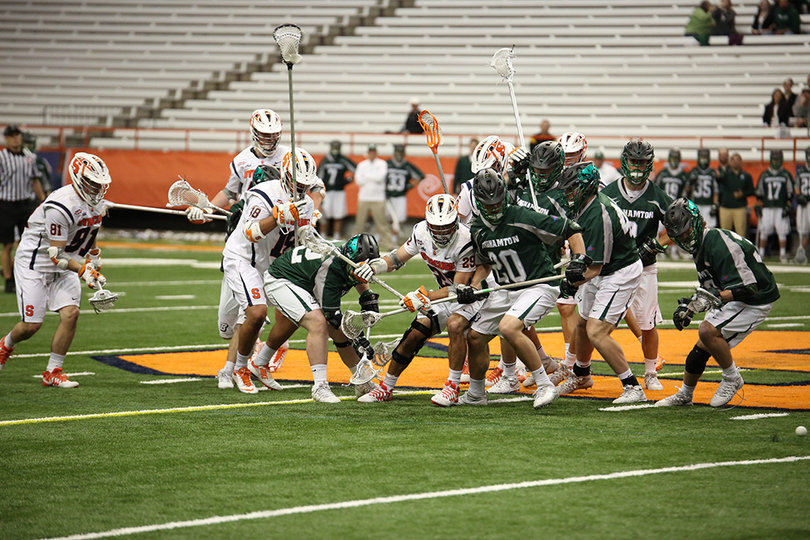 Several players on both teams chase down a loose ball. The Orange won the ground ball battle 29-21.