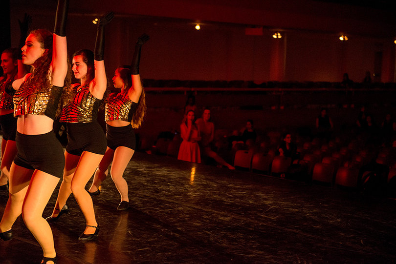 The Orange Pulse Dance Troupe President Emily Chase and the Artistic Director Nicole Stein look on from the crowd as the Theatre Jazz class performs their dance routine. 