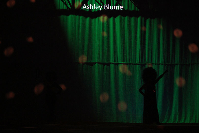 Models appear in the shadows before  gracing the stage in Ashley Blume's designs.