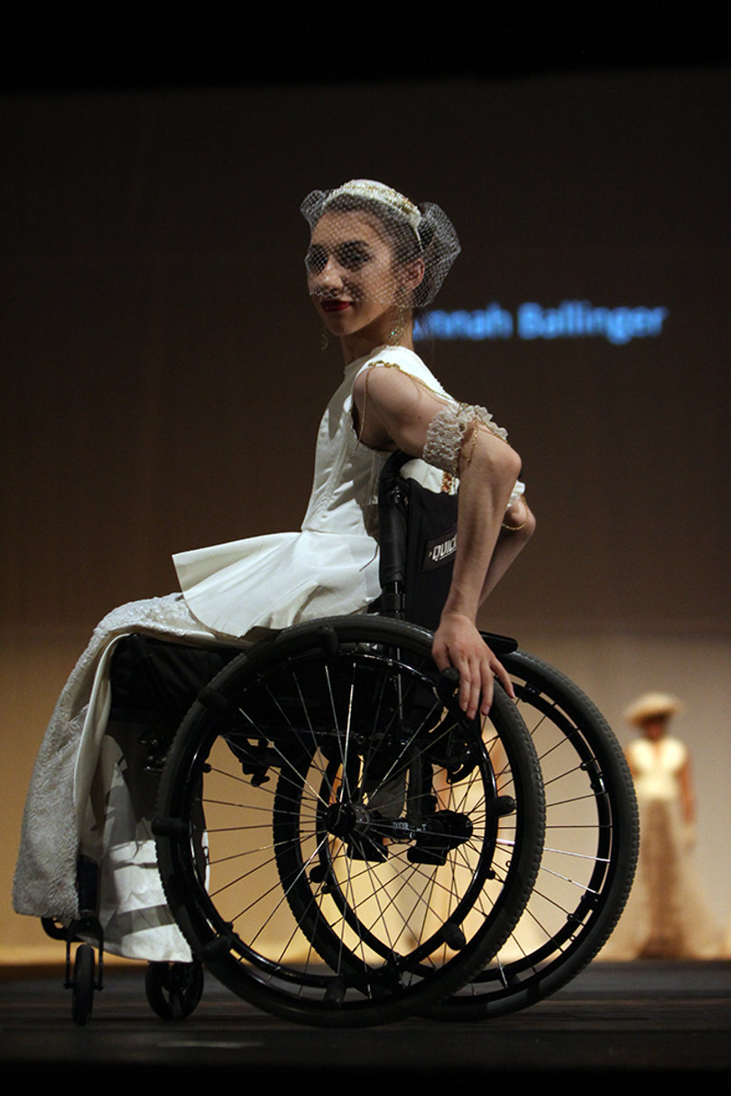 A model poses onstage in a wedding-esque look by Hannah Ballinger.