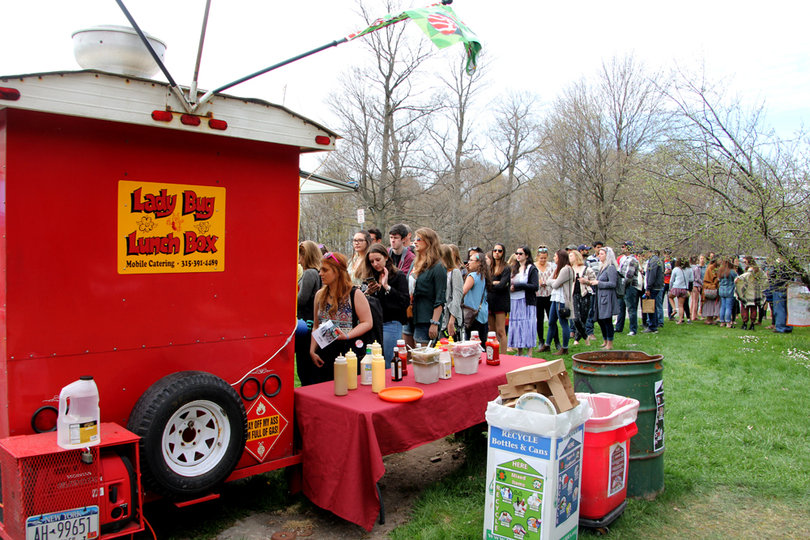 Students and local residents wait in line for the Lady Bug Lunch Box food truck at Earthfest.