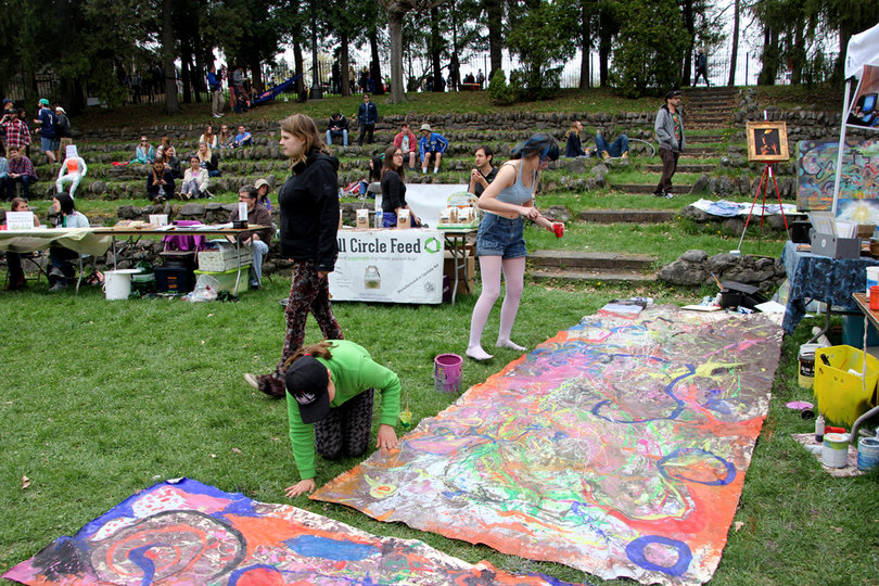 Students paint banners in Thornden Park on Sunday to celebrate Earthfest.