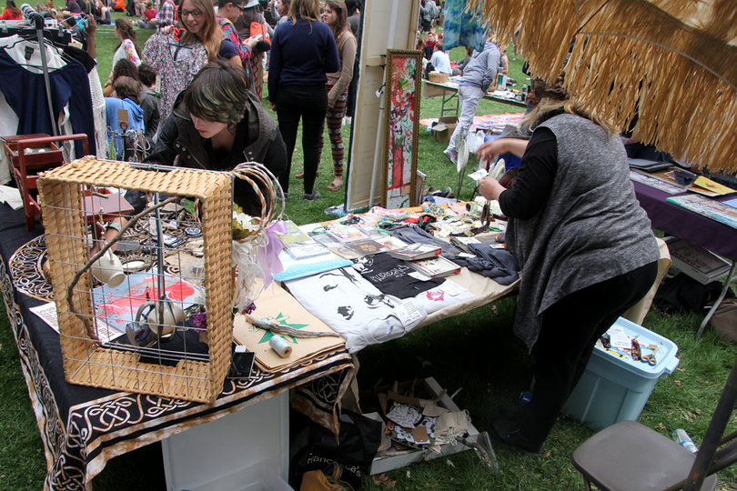 Local vendors sell handmade jewelry and T-shirts at Earthfest in Thornden Park on Sunday.