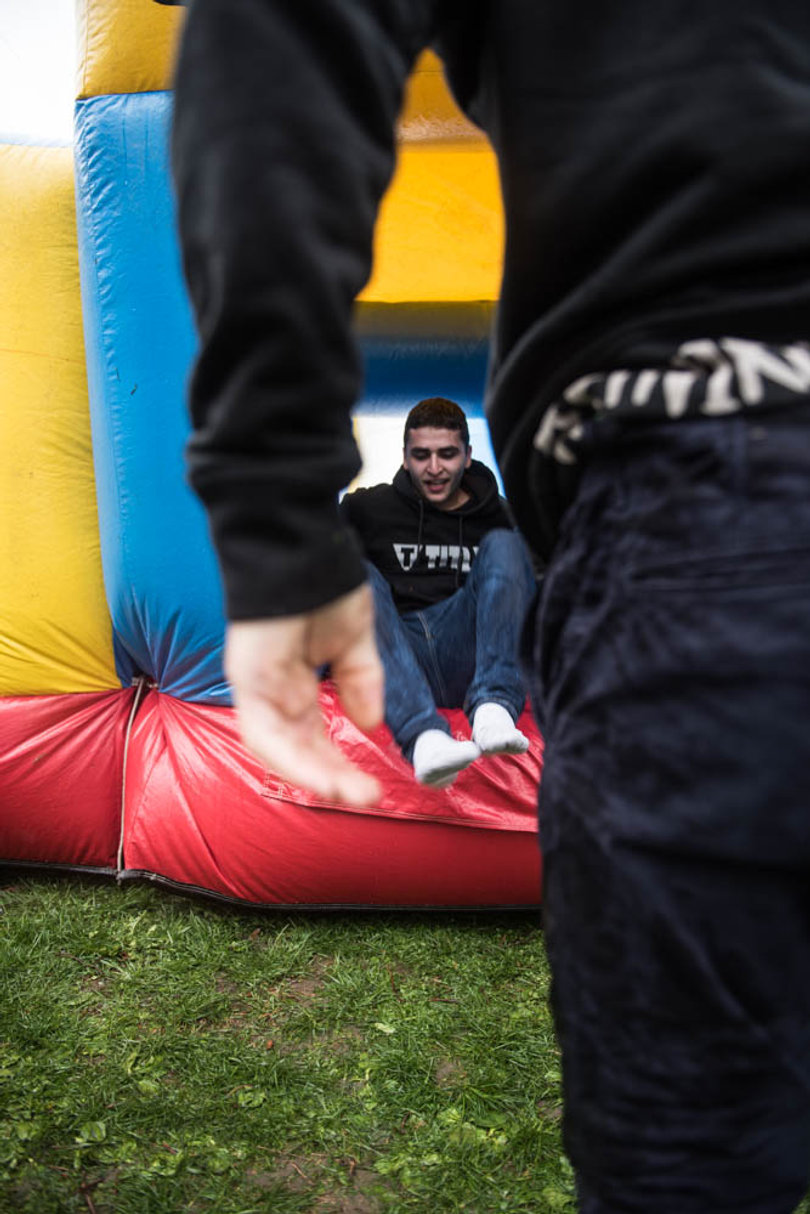 Aiden Haddad, a sophomore business major, races his friend on the bounce house course.