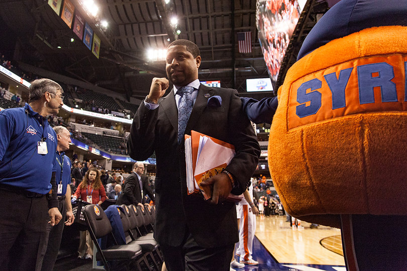 Assistant coach Cedric Solice pumps his fist while leaving the court in SU's 80-59 semifinal victory. Syracuse will face Connecticut on Tuesday for the national championship. 