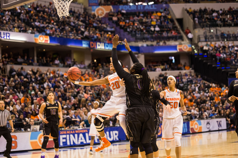 Sykes fends off on a layup for an acrobatic attempt. 