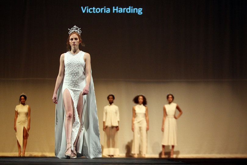 A model proudly struts from the lineup in this daring white dress by Victoria Harding.