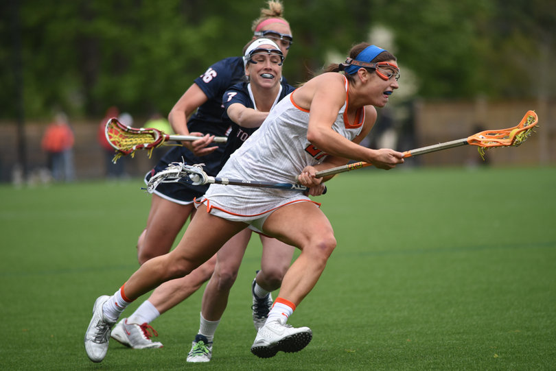 Kayla Treanor cradles past two SBU defenders. The SU senior tallied no points for just the first time this season. 