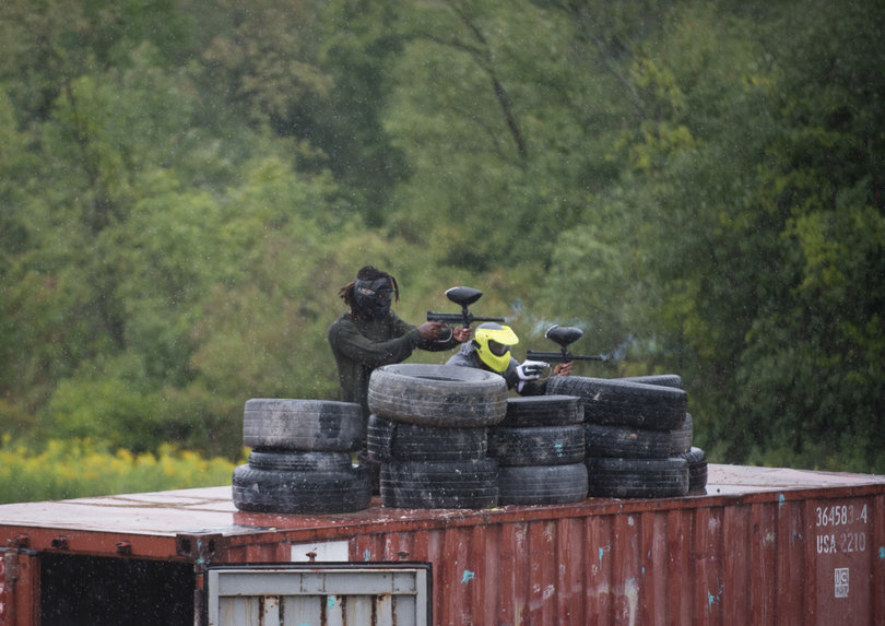 Freshman defensive back Scoop Bradshaw (left) and another teammate pick off players from atop a metal structure.