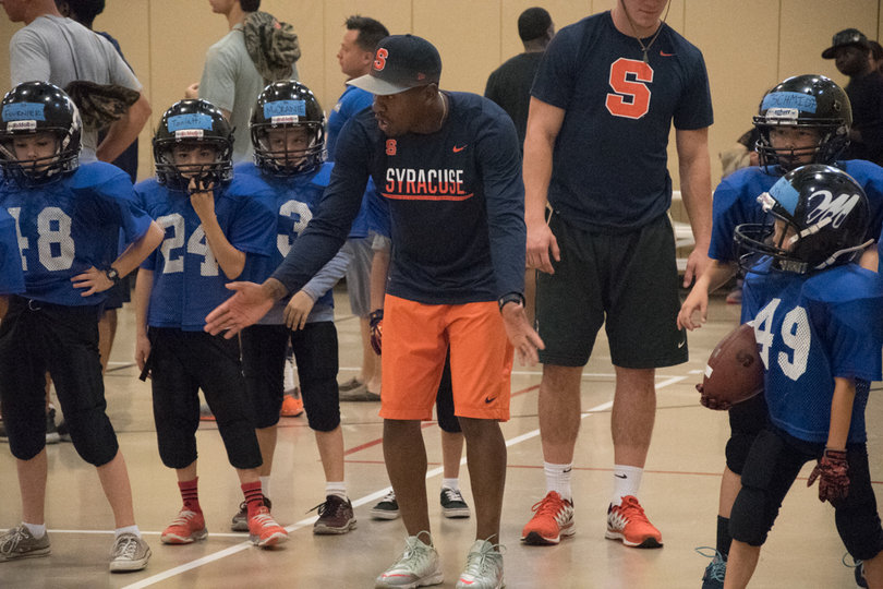 J.B. Gerald, SU's director of high school relations, breaks down a drill.