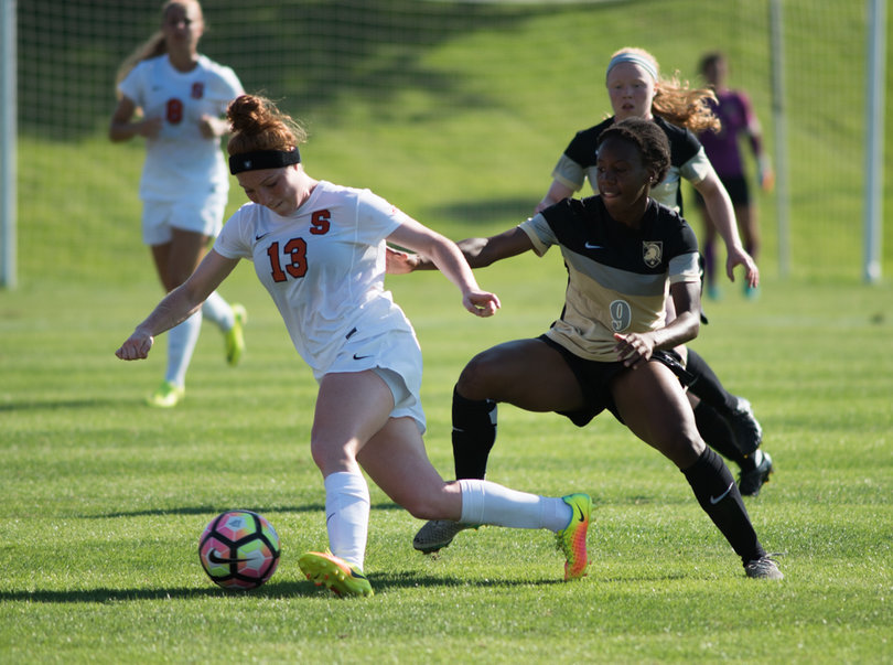 Iozzi dribbles around Jamison as another opponent draws close to provide help defense. 