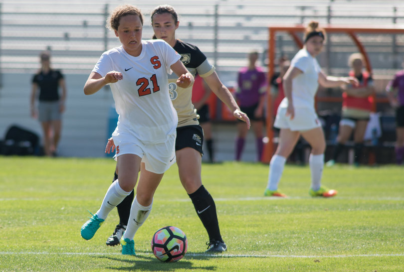 Midfielder Carolin Bader shields an opponent from the ball with her body. 