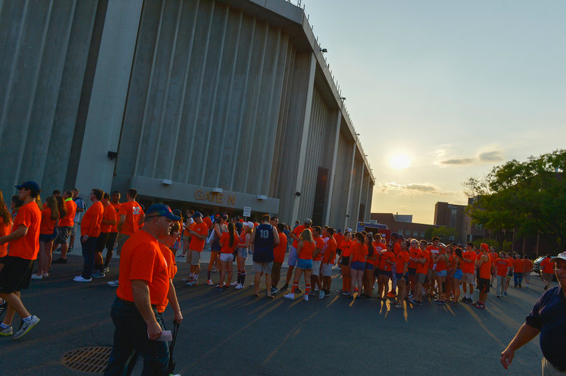 Hundreds of fans sporting orange flood the Carrier Dome parking lot on their way to a home game. 