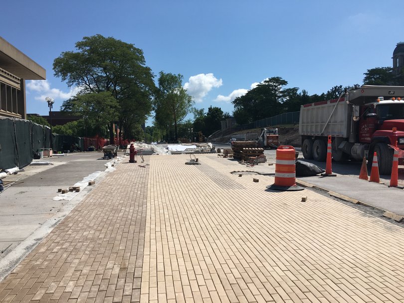 Stone tiles are being laid along portions of the University Place promenade. Photo taken Aug. 3, 2016