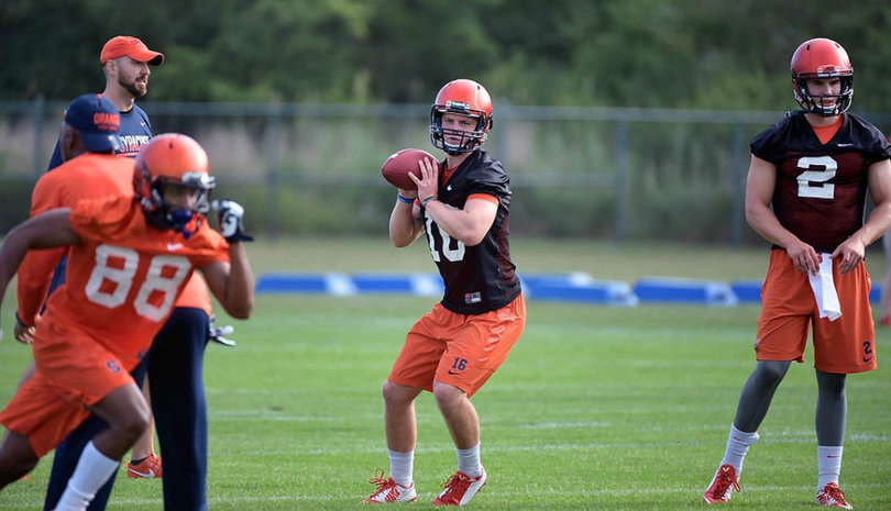 Backup quarterback Zack Mahoney winds up for a pass to wide receiver Clay Austin (88) as starting QB Eric Dungey (2) waits for his turn.