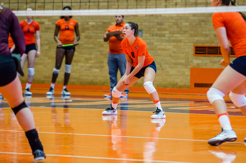 Setter Annie Bozzo (8) lines up for a dig within a few feet from the net.