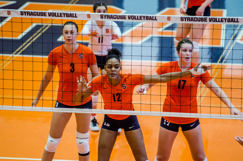 Anastasiya Gorelina (3), Amber Witherspoon and Mackenzie Weaver position themselves defensively in front of the net as defensive specialist Belle Sand (11) positions them from behind.
