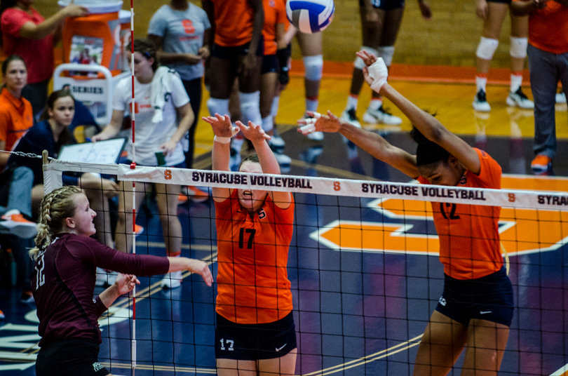 Mackenzie Weaver and Amber Witherspoon attempt to block a Colgate hit.