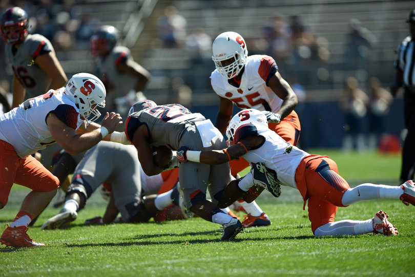 Newsome scurries forward as an SU defender drags him down.