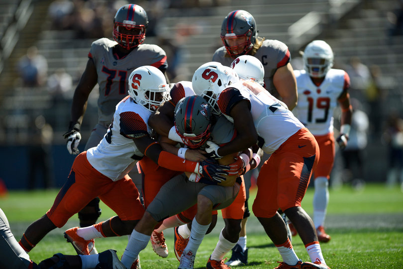 Syracuse defenders gang up on a Huskies player.