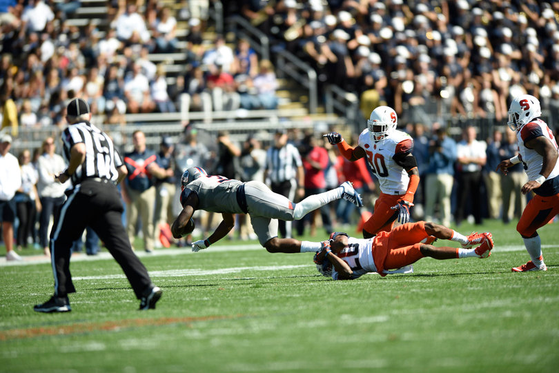 Cornerback Cordell Hudson snags a Huskies ball-carrier at their right ankle.