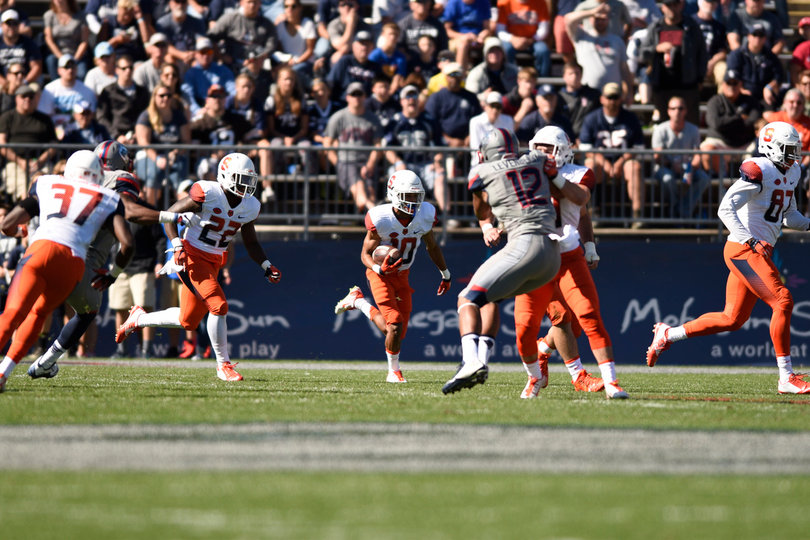 Freshman Sean Riley returns a kick as blockers set up around him.