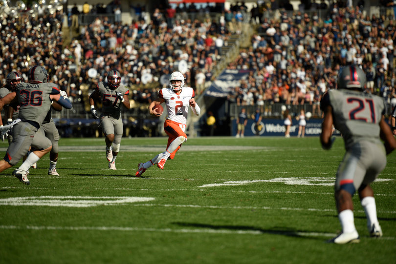 Syracuse sophomore quarterback Eric Dungey escapes UConn defenders. He had one rushing touchdown.