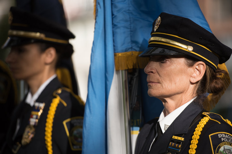 Syracuse first responders stand during a moment of silence Sunday.
