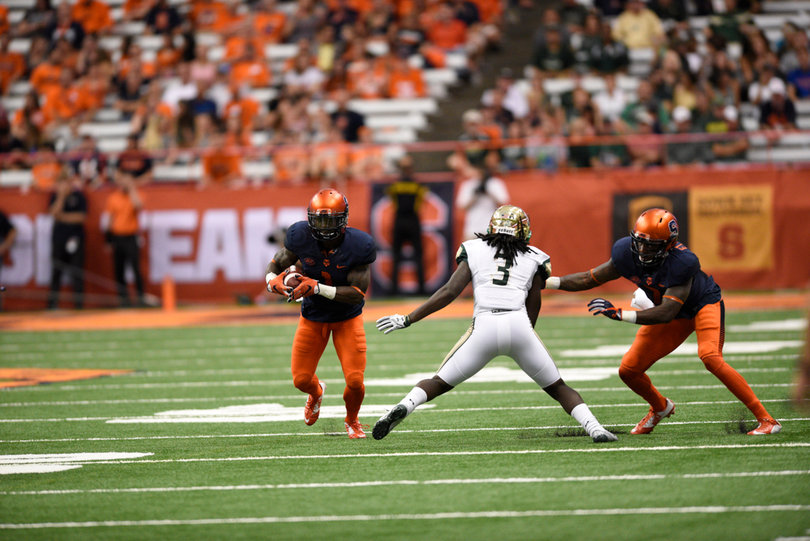 Brisly Estime looks to get upfield as USF's Deatrick Nichols defends.