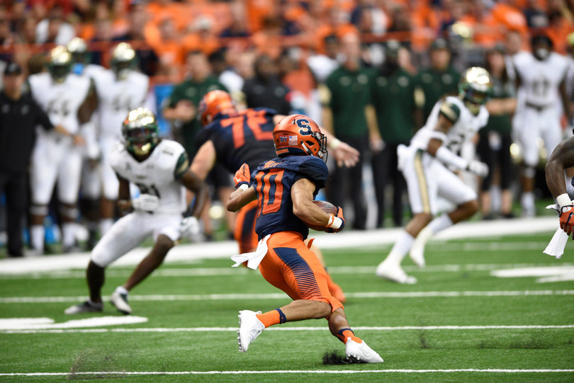 Riley runs with the ball tucked in his right arm. He returned eight kicks for 193 yards.