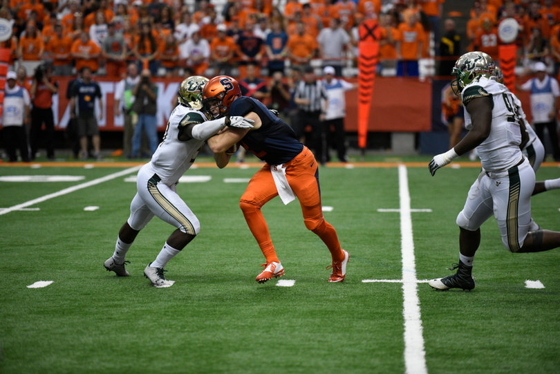 Dungey gets wrapped up by a USF defender. He went 32-of-48 passing on Saturday.