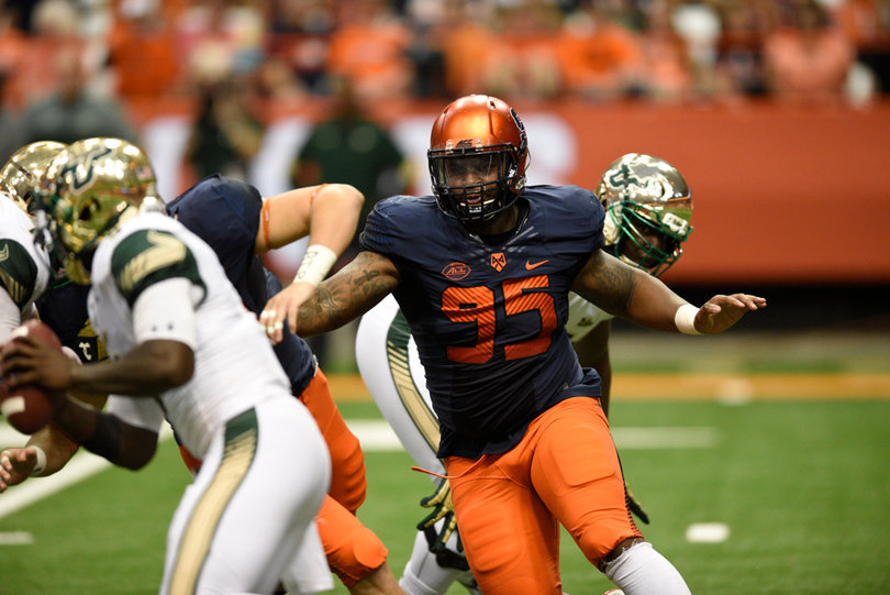 Slayton gets into the Bulls' backfield as he looks to make a play on the ball.