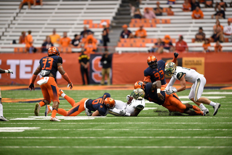 Syracuse safety Rodney Williams (6) wraps up USF wide receiver Chris Barr.