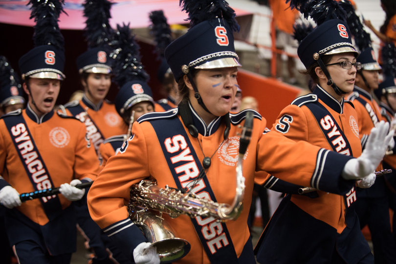 The Syracuse University marching band works on prepping up the crowd. 