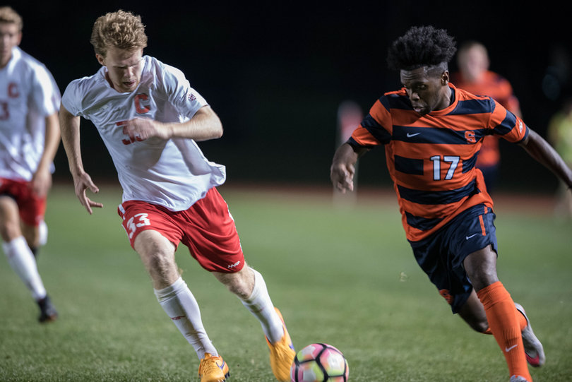 Chris Nanco uses his speed to try to get around former Syracuse player Spencer Kopko, who transferred to Cornell.