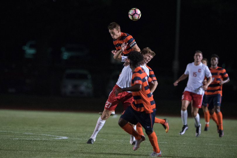 Oyvind Alseth rises up above a Cornell defender and heads a ball forward toward Chris Nanco.
