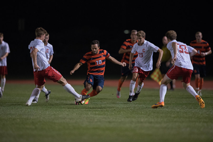 Orange midfielder Sergio Camargo makes a move with several Cornell defenders closing in on him. Camargo finished with three shots.