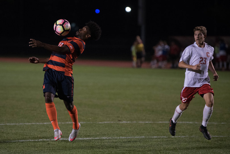 Chris Nanco settles a ball of his chest at the edge of the box with a defender looking on.