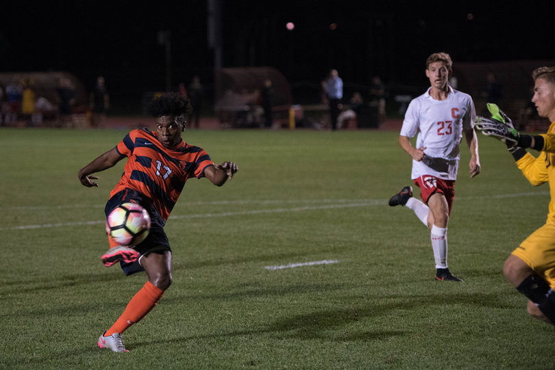 Chris Nanco volleys the ball toward the Cornell goalie and net.