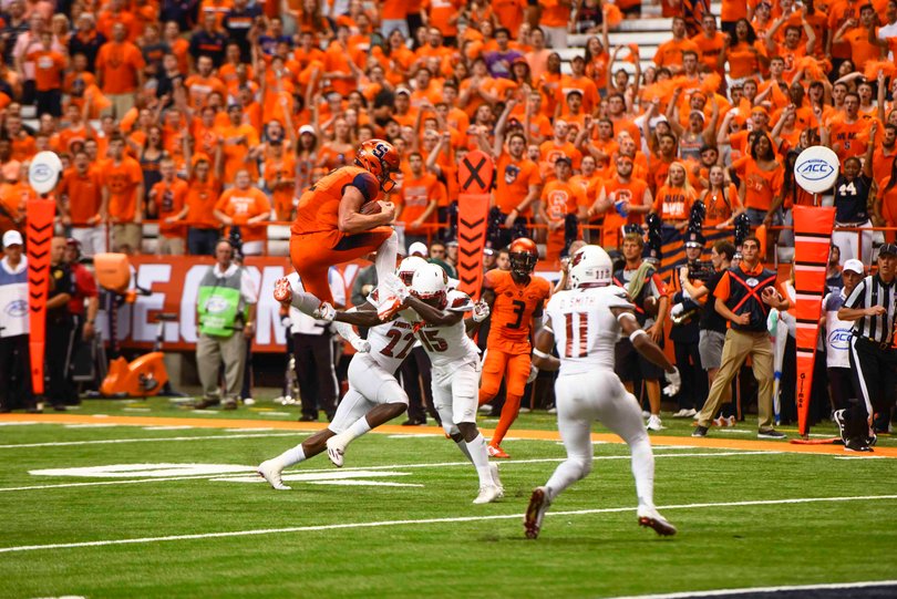 Quarterback Eric Dungey attempts to hurdle a UofL defender. He hurdled last October at Virginia.