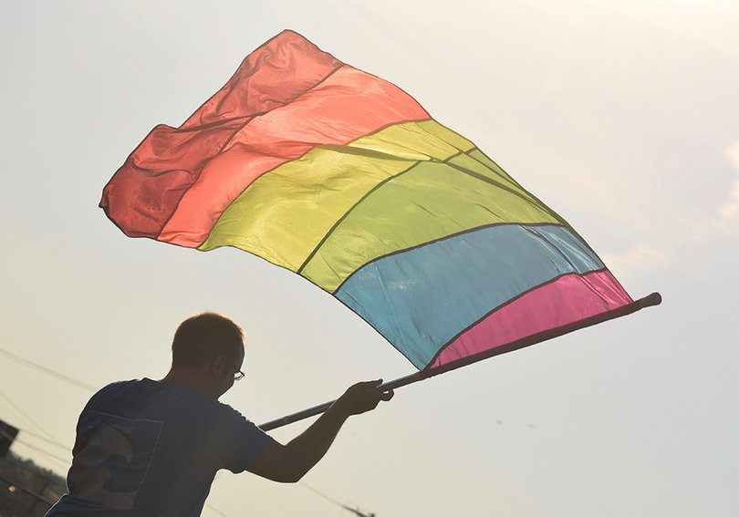 Rainbow flags wave as a LGBT choir performs at the New York State Fair.