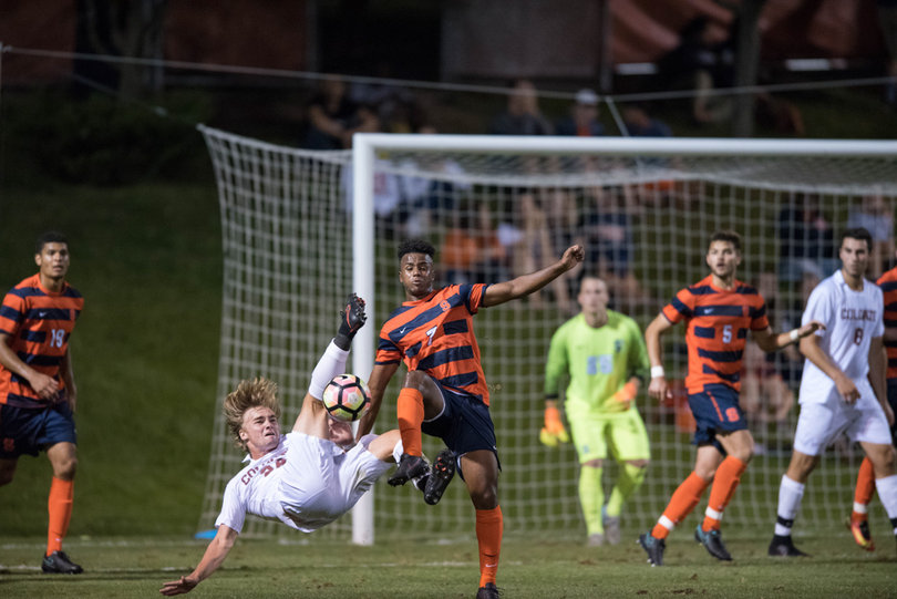 Adams fights off Tim Oberg for the ball. 
