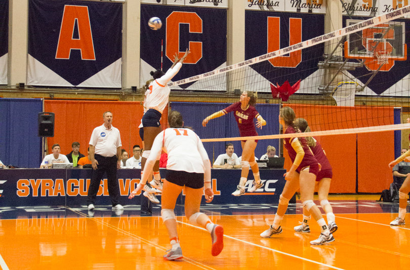 A Boston College player launches the ball onto Syracuse's side of the net.
