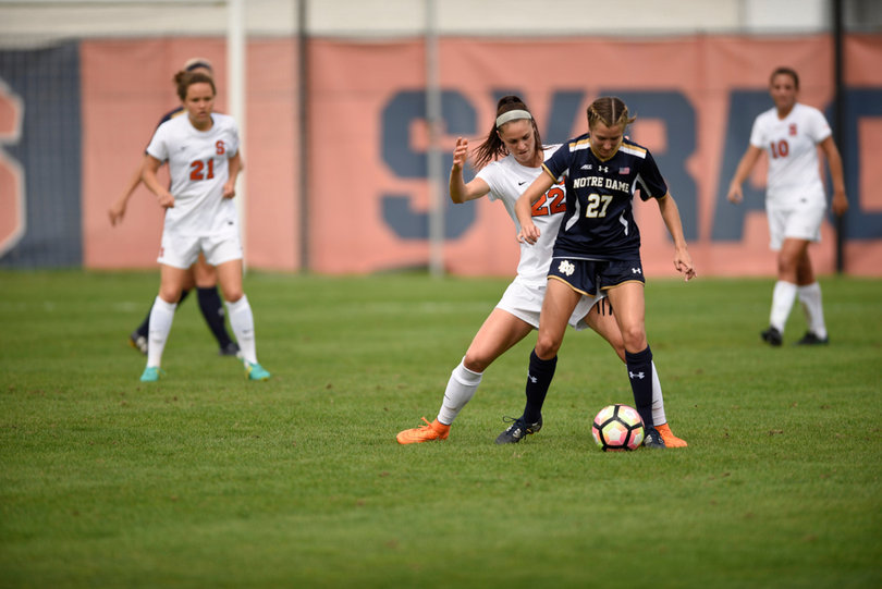 Stephanie Skilton tries to poke the ball away from UND's Kaleigh Olmsted. The Orange defense held Notre Dame to just one goal.