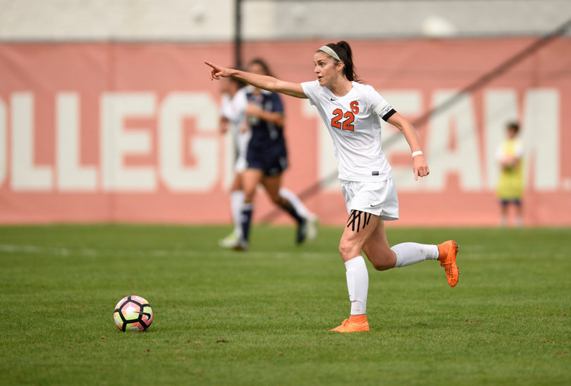 Stephanie Skilton points up the field, directing her teammates as she prepares to pass the ball.