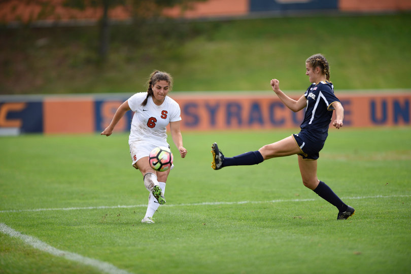 Orange defender Natasha Tcheki-Jamgotchian tries to kick the ball past a Notre Dame defender.