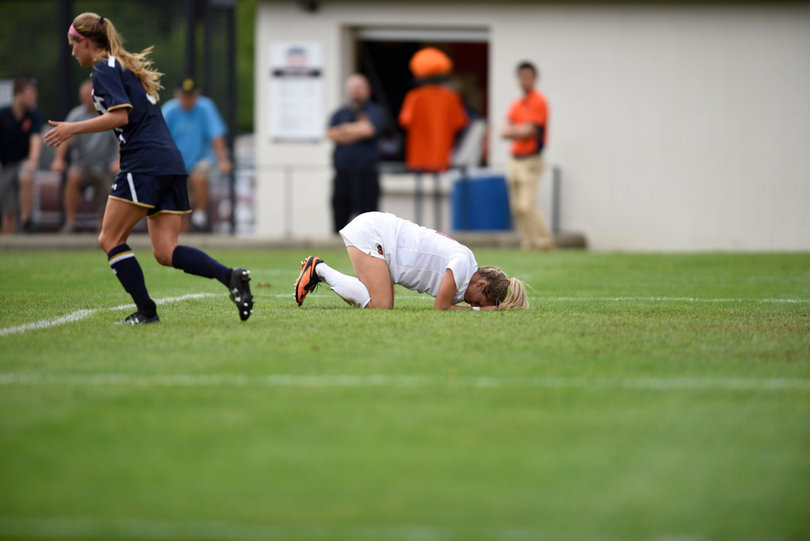 Eva Gordon lays on the ground with her face in her hands. Gordon led Syracuse with five shots and three on goal.