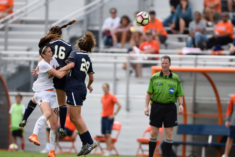 Orange forward Stephanie Skilton jumps up for a header, battling with Notre Dame's Taylor Klawunder (29) and Sandra Yu (16). Klawunder scored UND's only goal.